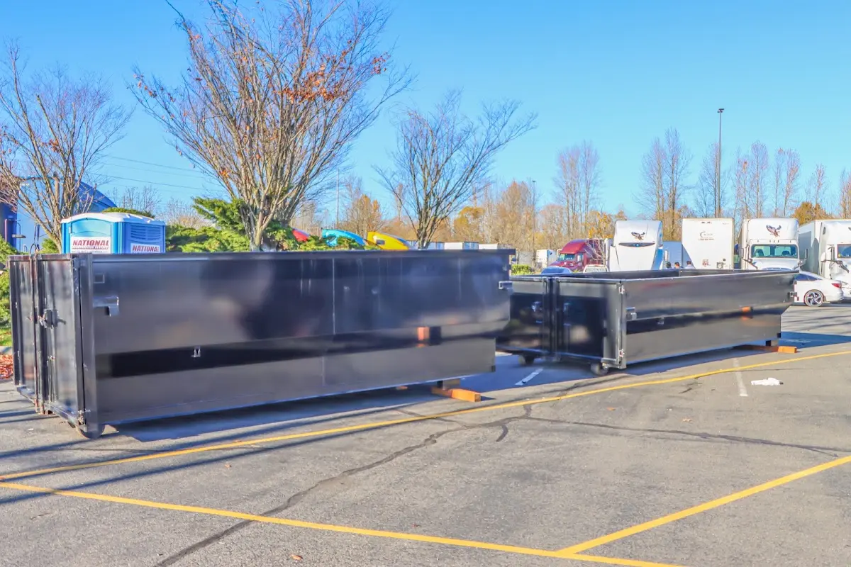 Professional dumpster rental service with roll-off container on residential driveway in Roseville